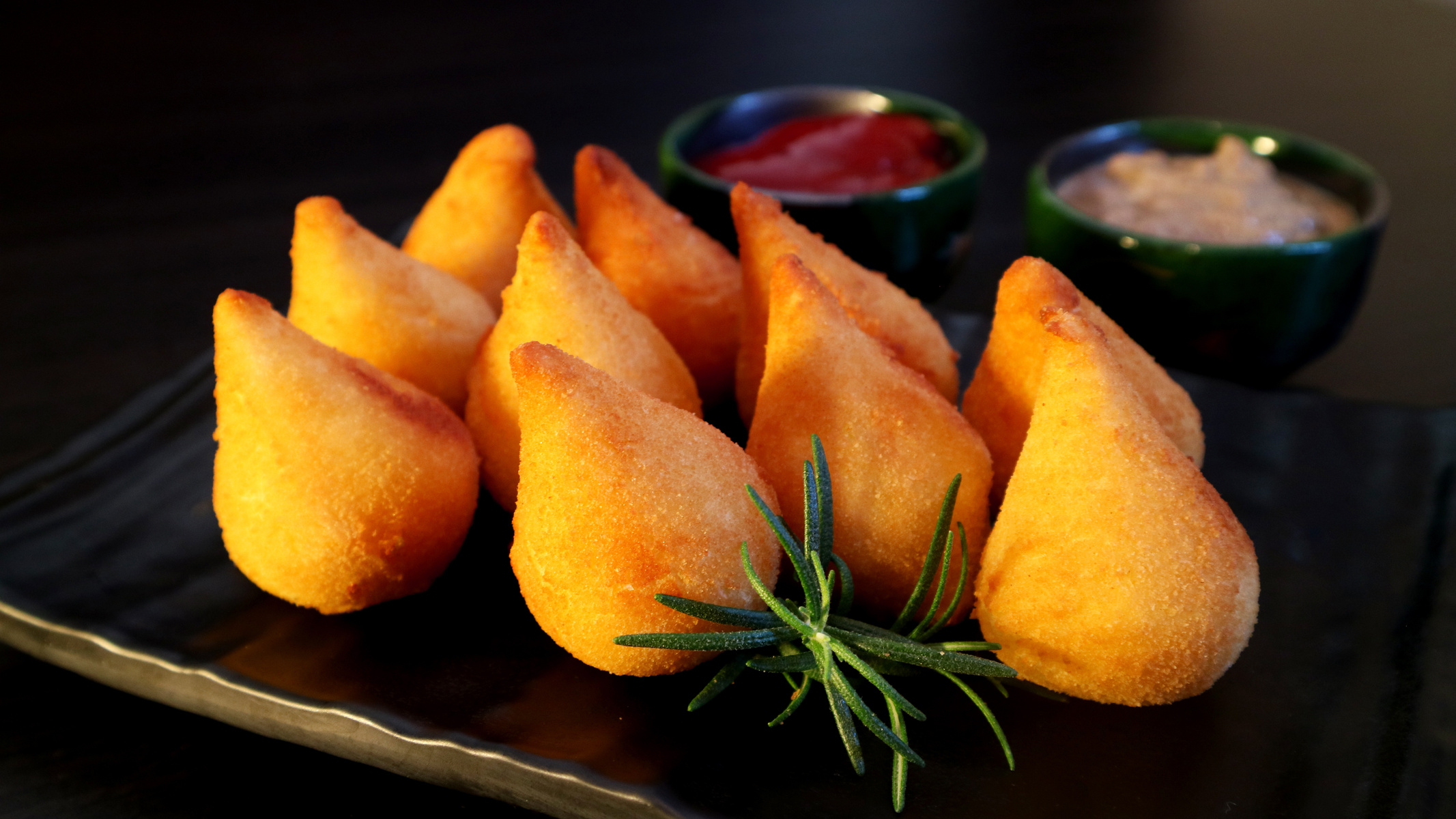 Coxinhas Brazilian snack stuffed with chicken on dark background